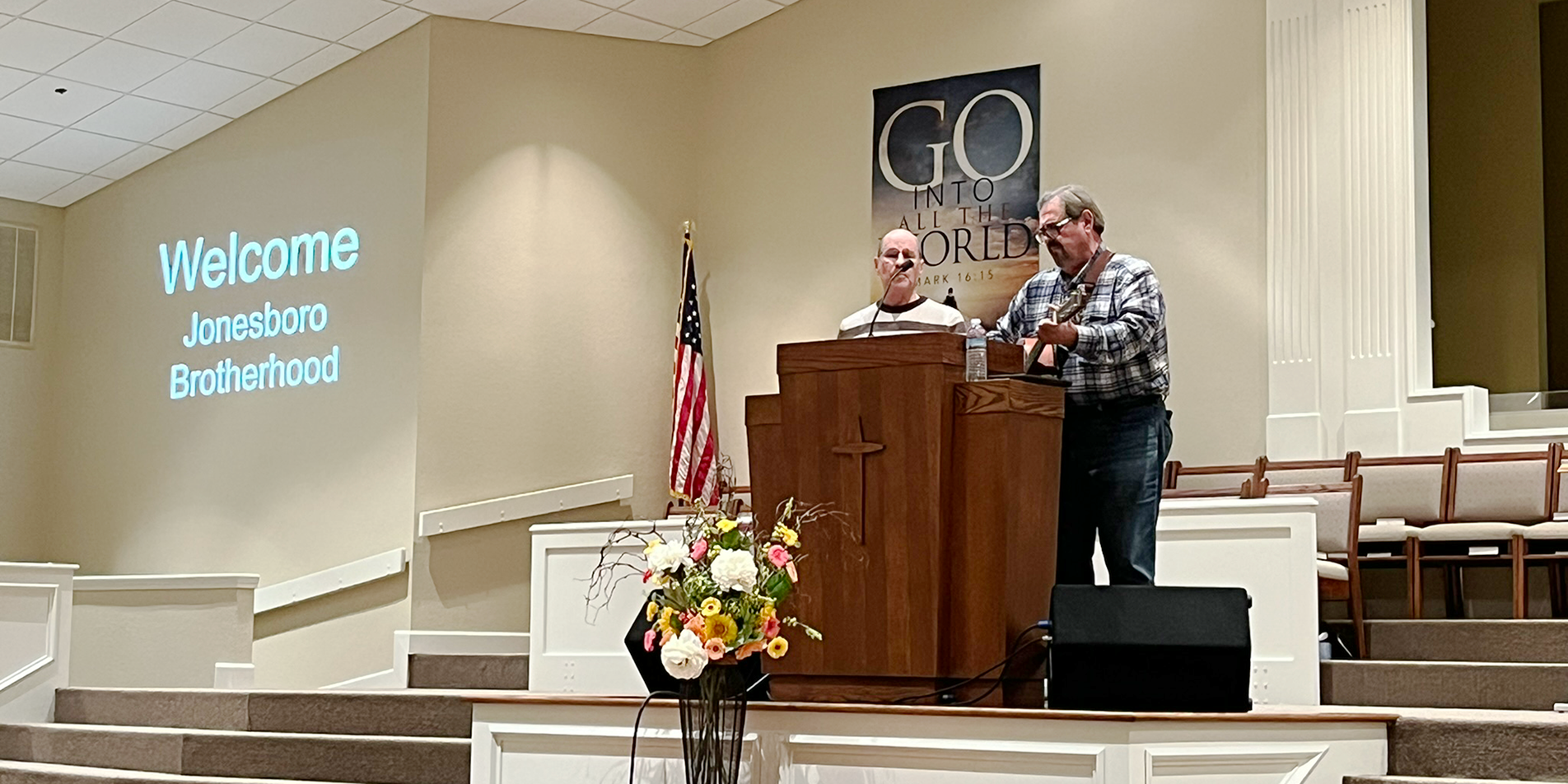 Photo of two men singing at church